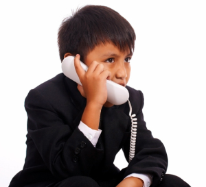 Young Boy In A Suit Having A Chat On The Phone